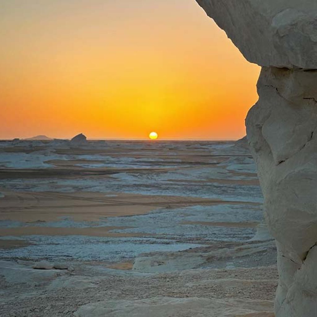 The unique chalk-white rock formations of the White Desert bathed in the soft, warm light of a desert sunrise near Bahariya Oasis