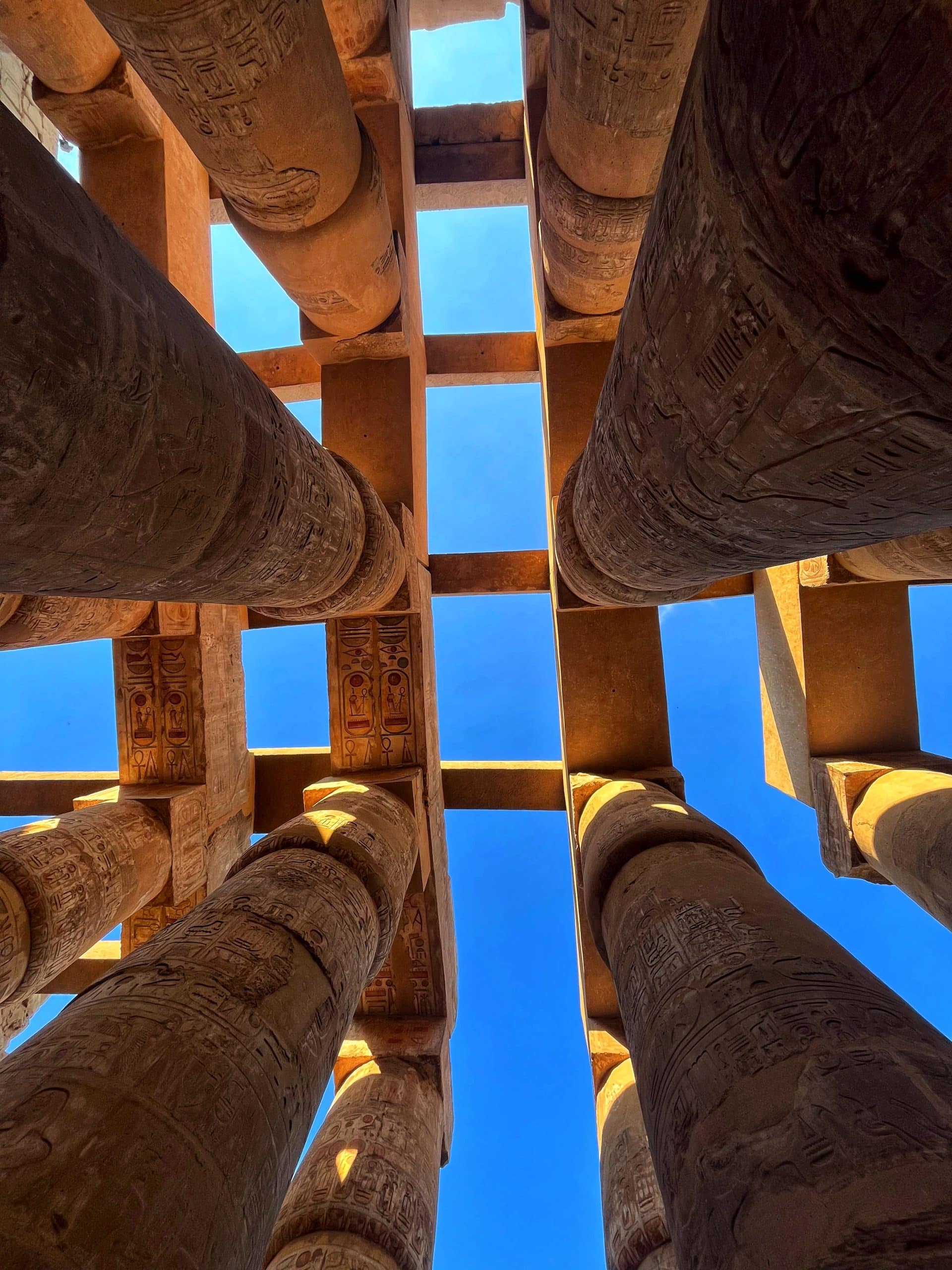 Giant columns of Karnak Temple in Luxor under a blue sky
