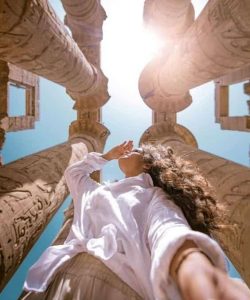 Traveller looking up at the columns of an ancient Egyptian temple